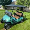 2017 EZGO TXT gas golf cart in teal with saddle tan seats
