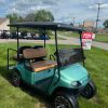 front view of the teal 2017 EZGO TXT gas cart and tinted windshield