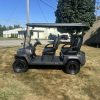2025-epic-e40fx-lithium-golf-cart-5 side profile of the 2025 Epic E40FX lithium on black wheels