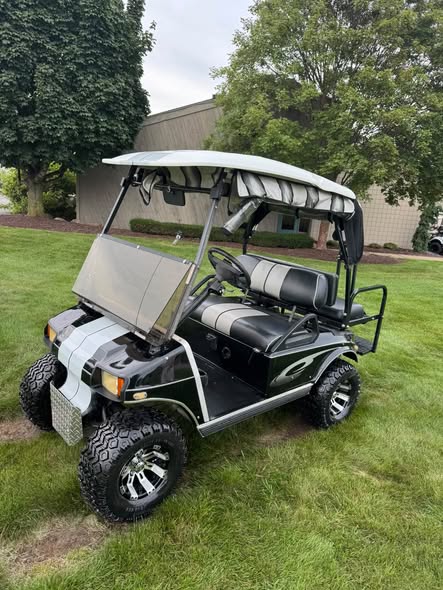 black Club Car DS 48V electric golf cart front angle with stripes