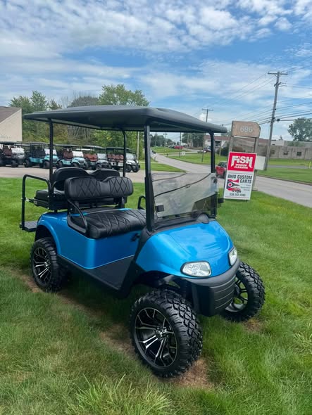 front view of the blue EZGO RXV EFI cart and tinted windshield
