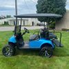side profile of the lifted blue EZGO RXV EFI golf cart