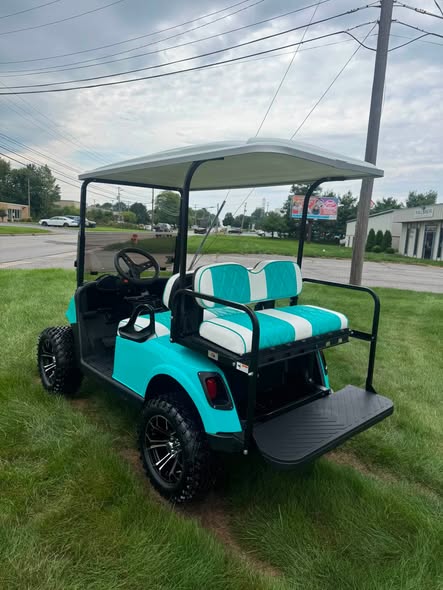 lifted-teal-ezgo-rxv-gas-cart-4 lifted teal EZGO RXV golf cart rear view with taillights and footplate