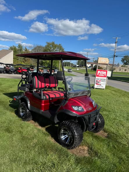 red ICON i40L golf cart with folding windshield and striped seats