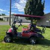 red ICON i40L electric golf cart full side profile with lift kit