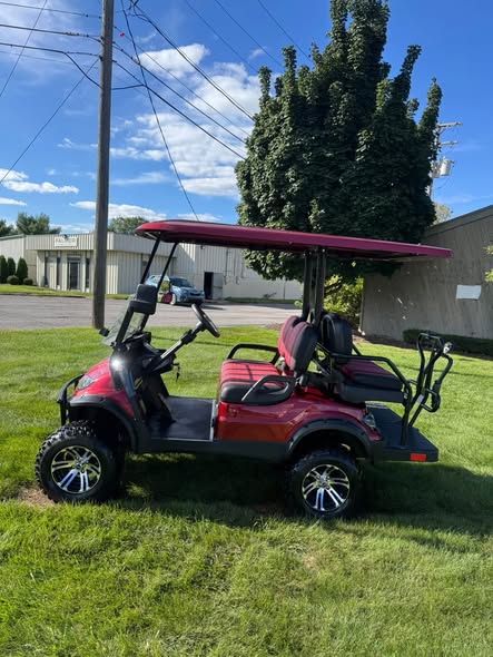 red ICON i40L electric golf cart full side profile with lift kit