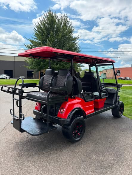 red-2023-epic-e60l-6-passenger-golf-cart-3 rear view of red Epic E60L showing rear flip seat and grab bar