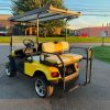 yellow-ezgo-express-s4-golf-cart-4 yellow EZGO Express S4 golf cart rear angle with white seats
