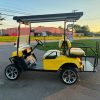 yellow-ezgo-express-s4-golf-cart-5 side profile of the yellow EZGO Express S4 cart with extended roof