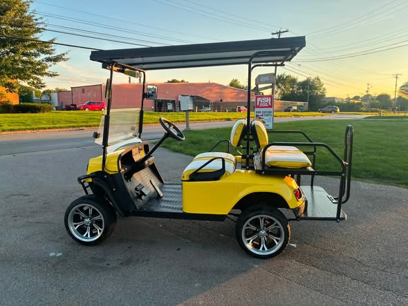 yellow-ezgo-express-s4-golf-cart-5 side profile of the yellow EZGO Express S4 cart with extended roof